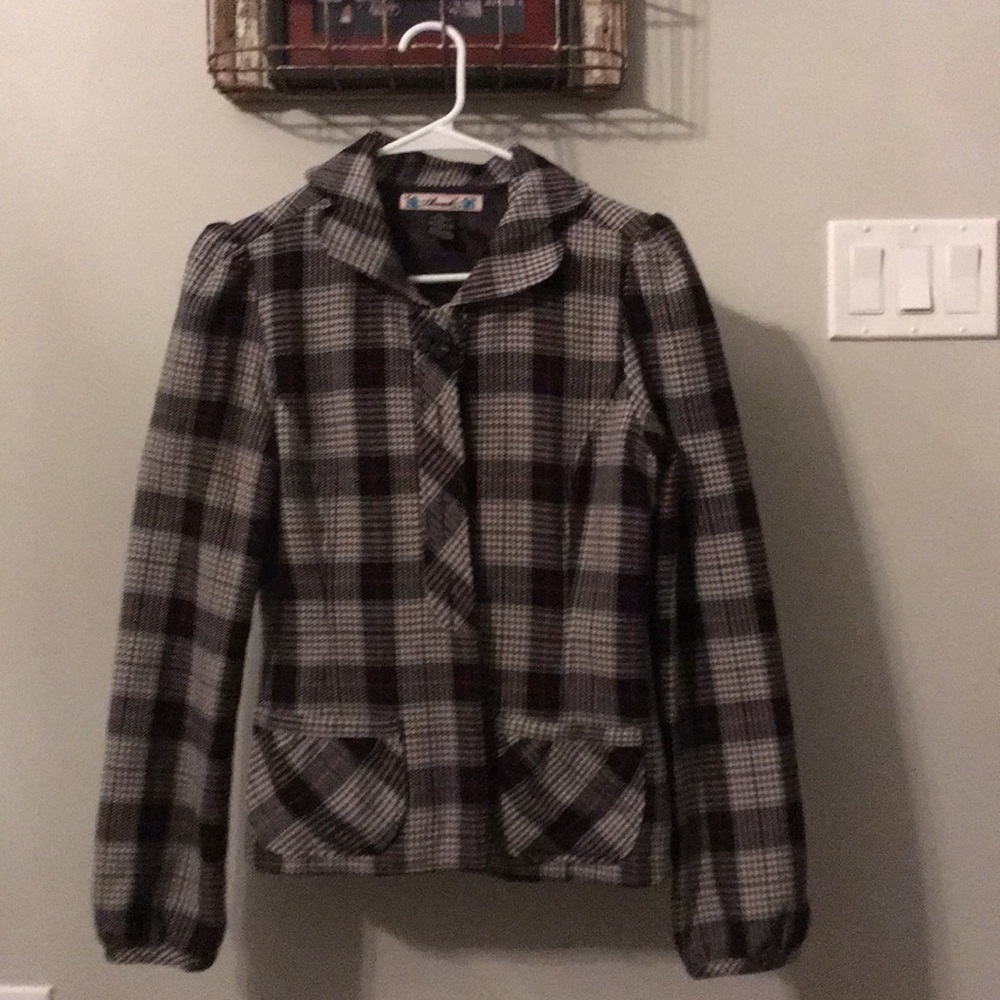 Women’s small jacket with black lining.